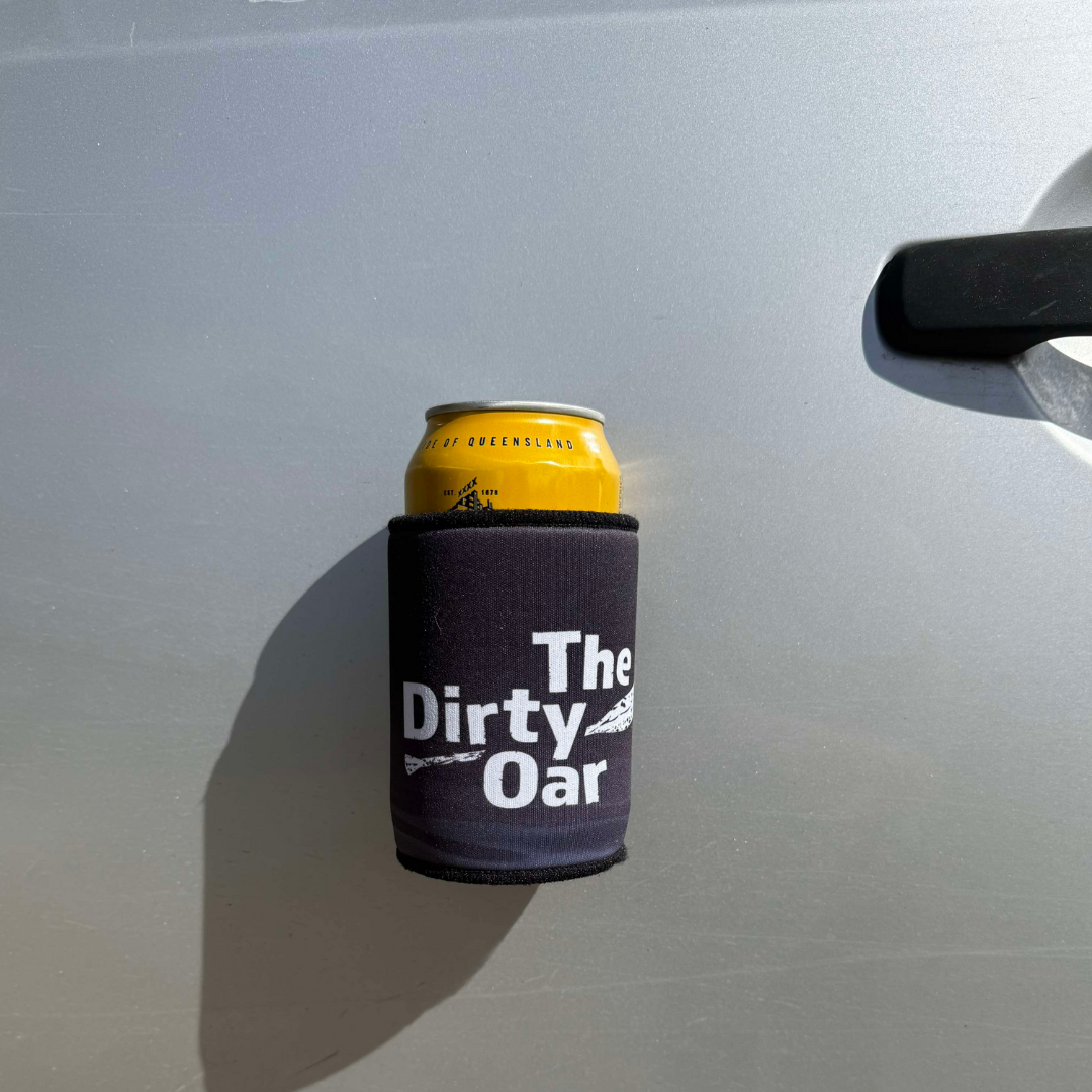 Can of beer in a 'The Dirty Oar' cooler attached to a car door.