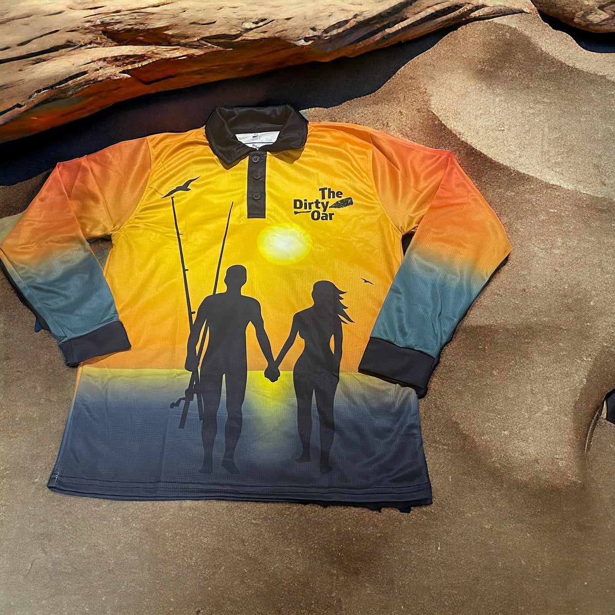 The Dirty Oar Couples Fishing Shirt n sandy background with log