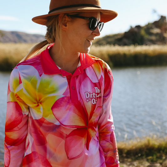 Person wearing Frangipani Womens Fishing Shirt, standing outdoors by a body of water.