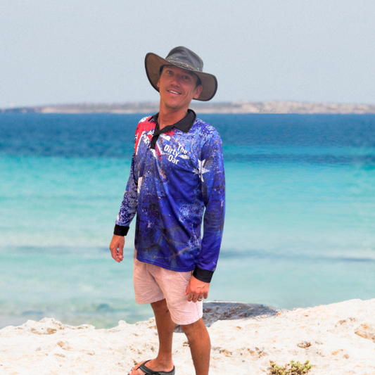 A person standing by the sea The Dirty Oars The Aussie Mens Fishing Shirt along with a cowboy hat.