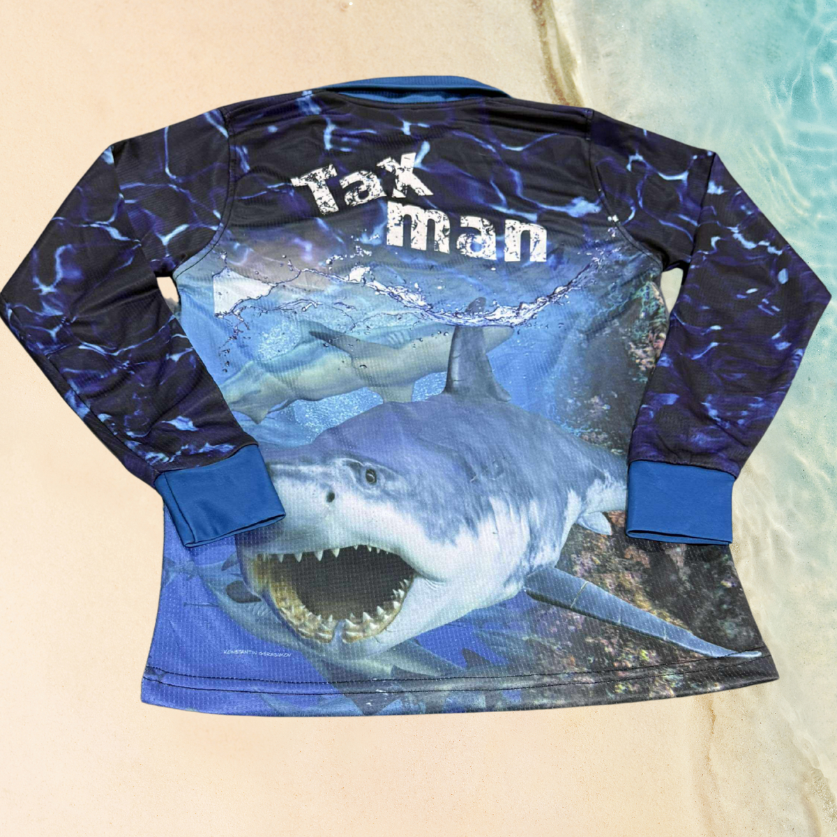 The Dirty Oar Taxman Kids Fishing Shirt shirt with shark graphic and 'Tax man' text on a beige background