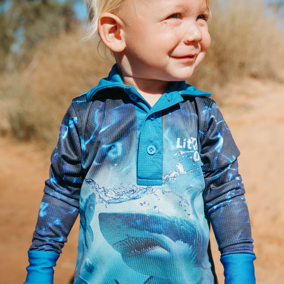 Child wearing The Dirty Oar Taxman Kids Fishing Shirt outdoors.