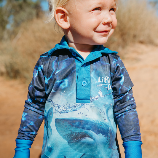 Child wearing The Dirty Oar Taxman Kids Fishing Shirt outdoors.