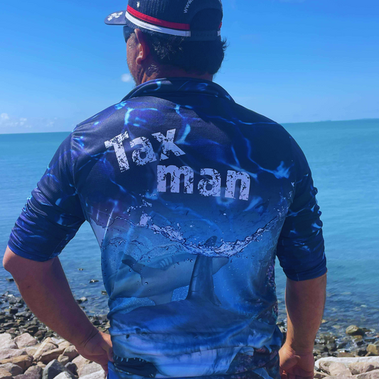 Person wearing The Dirty Oar Taxman Mens Fishing Shirt Near the Ocean.