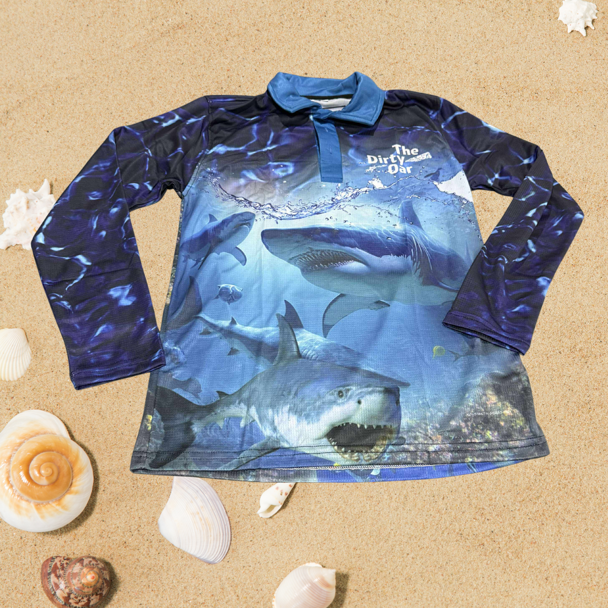 The Dirty Oar Taxman Mens Fishing Shirt on a sandy background.