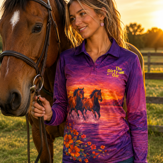 Woman wearing The Dirty Oar's Wildlife Womens Fishing Shirt with a horse design standing next to a horse in a field at sunset.