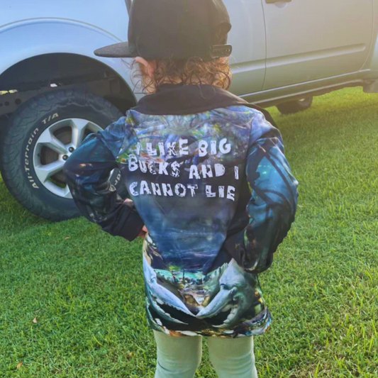 A child wearing the Dirty Oars Mud Crab Kids Fishing Shirt is standing near a vehicle.