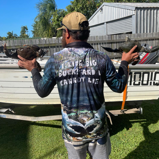Man holding 2 big bucks wearing The Dirty Oar Mud Crab Mens Fishing Shirt in front of tinny.