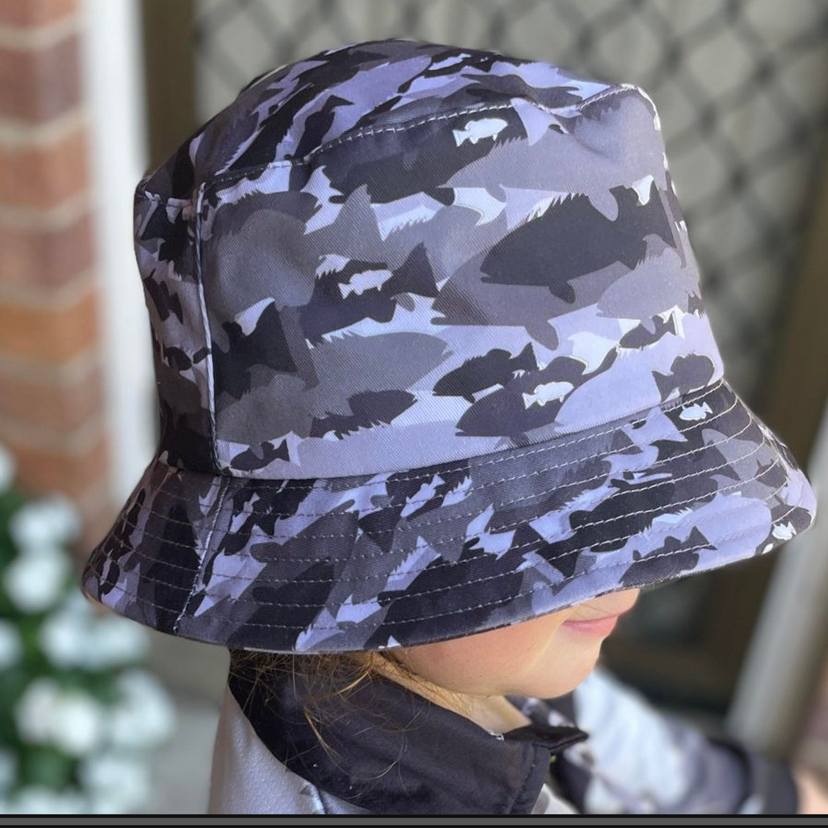 The Dirty Oar Coral Trout Kids Bucket Hat on Childs head.