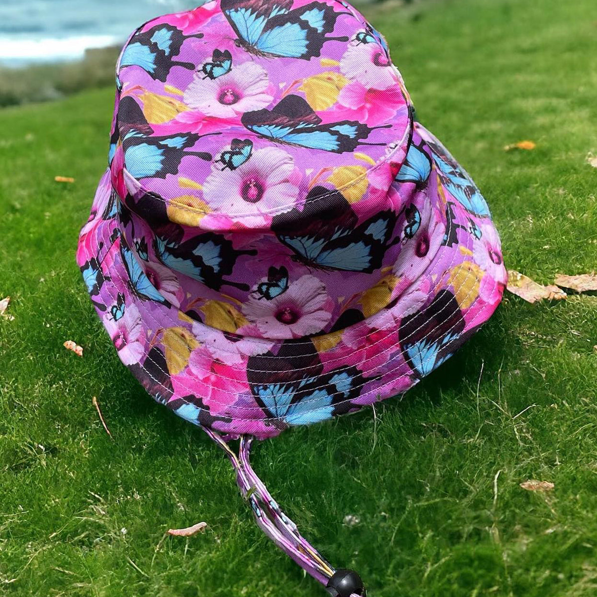 The Dirty Oar Princess Kids Bucket Hat on grass background.
