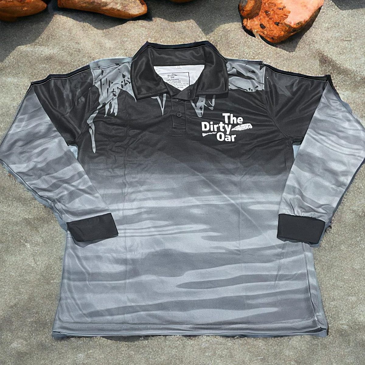 The Dirty Oar Mens Fishing Shirt Black on sandy background