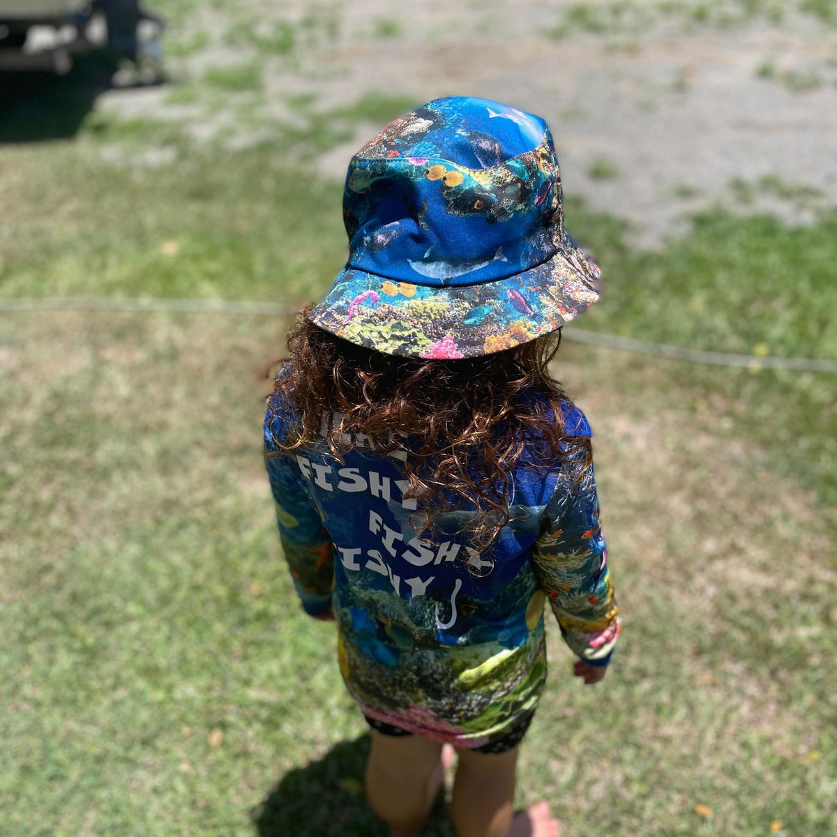 child wearing The Reef Kids Bucket Hat and The Reef Kids Fishing Shirt